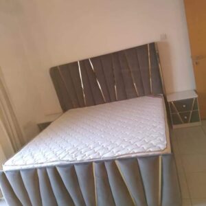 Modern Geometric Tufted Bed with Gold Accents
